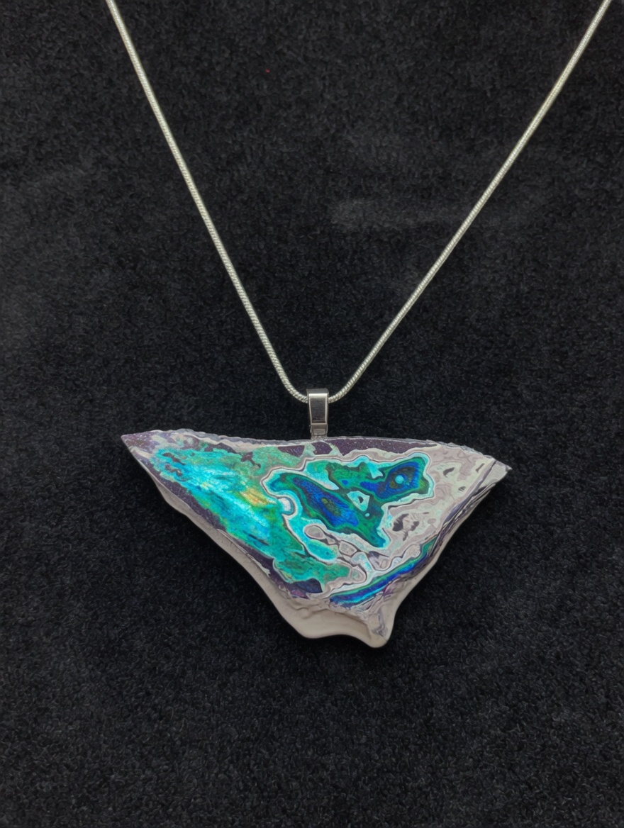 Fordite teal shard pendant — irregular cut showing teal and blue-purple bands